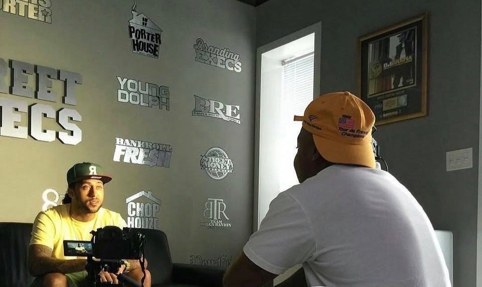 A camera filming an interview in a music studio